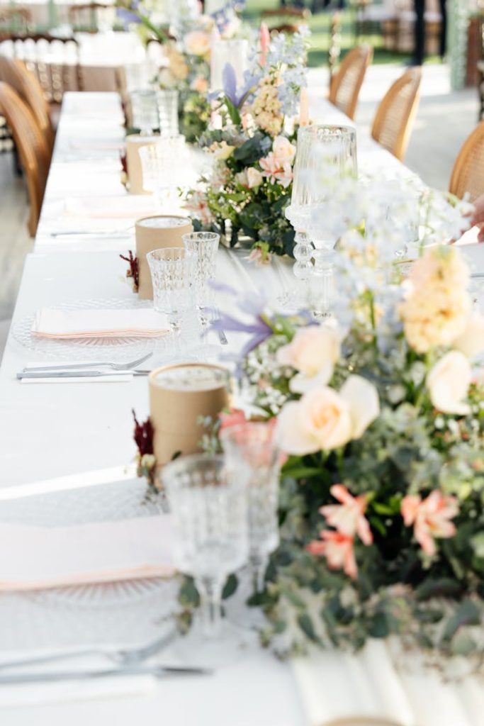 a-table-with-wedding-decorations-24023403 Beautifully decorated wedding reception table with colorful floral centerpieces and elegant glassware.